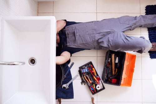 commercial-5-126121466-overhead-shot-male-plumber-wor