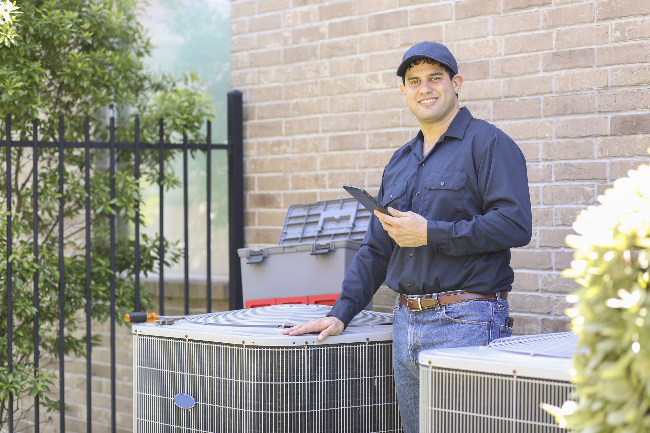 Smiling man with air conditioner